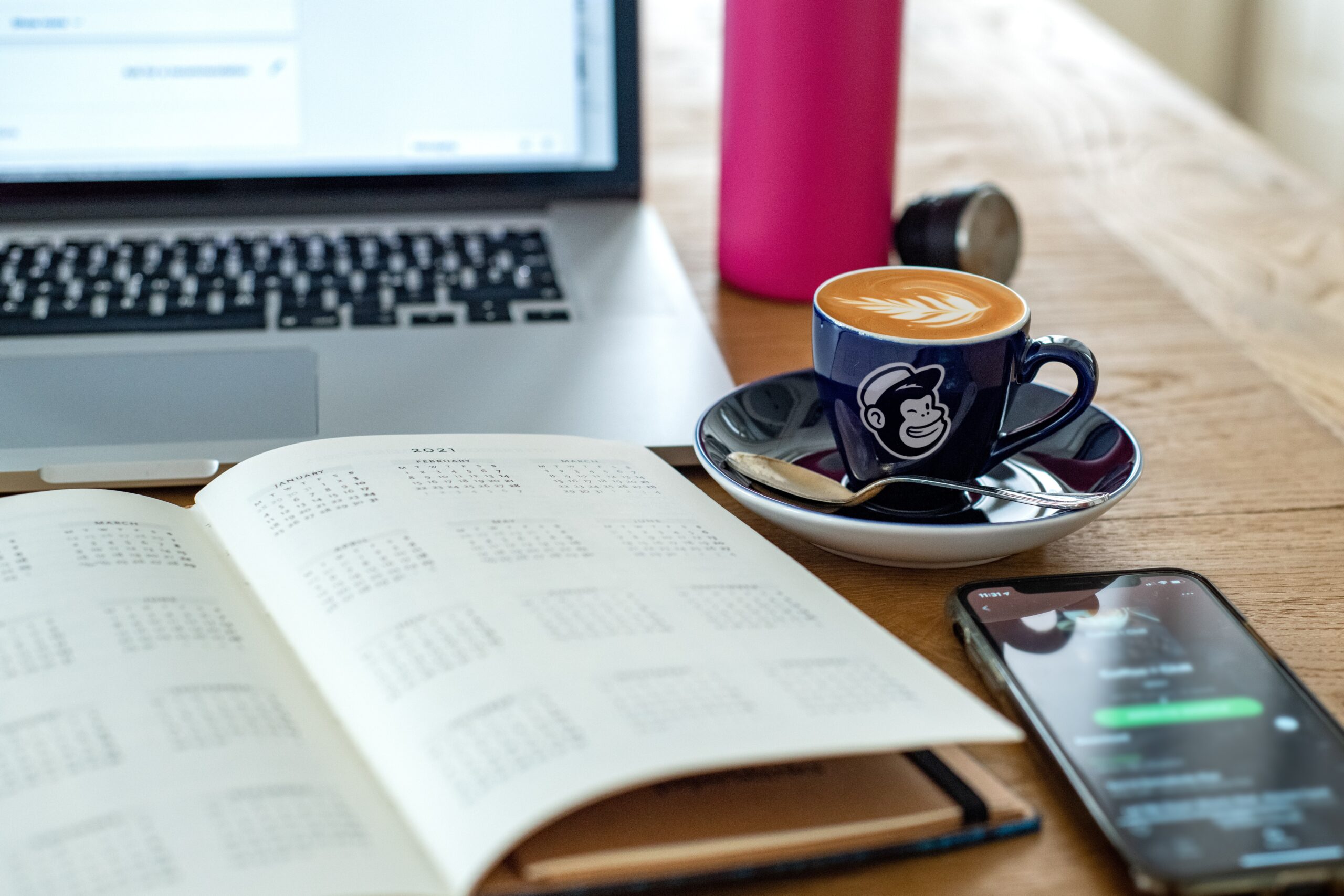 notebook and coffee on a desk